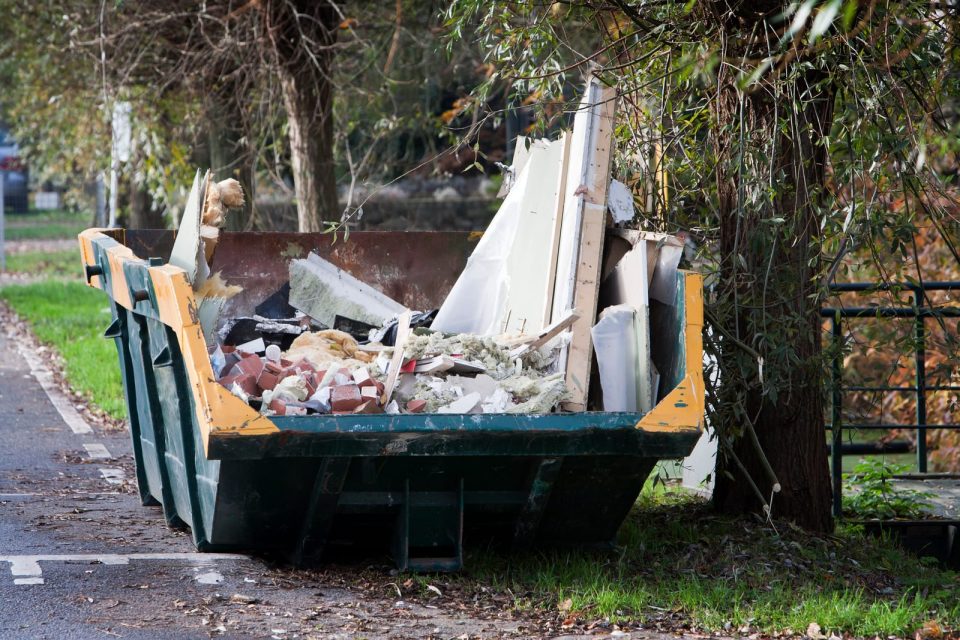 A small 4-yard midi skip, ideal as a domestic skip for garden clearances or small home renovations, placed on a private driveway.